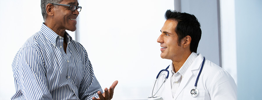 Picture of a man speaking with a doctor.